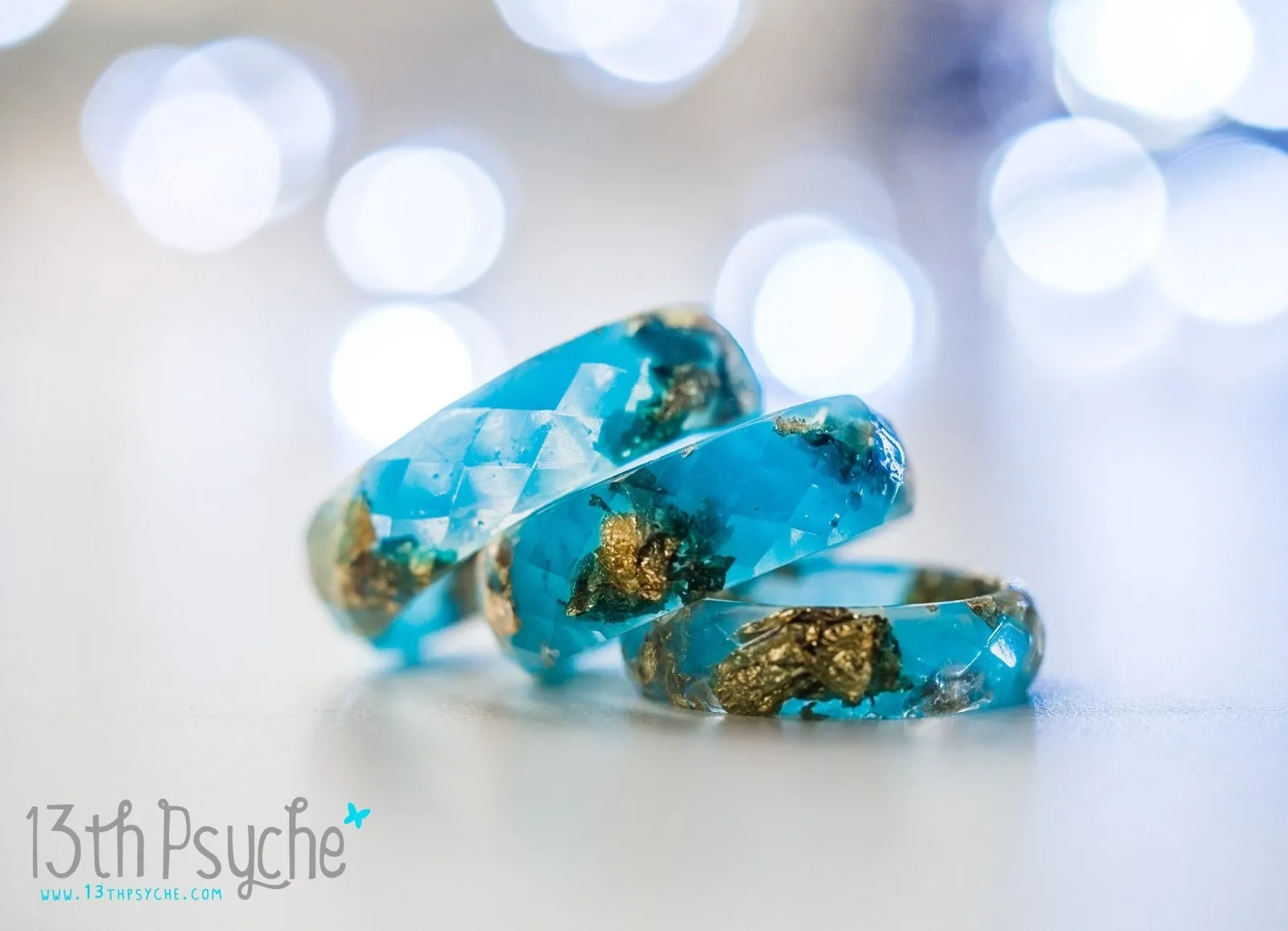 Light blue and gold flakes faceted resin ring